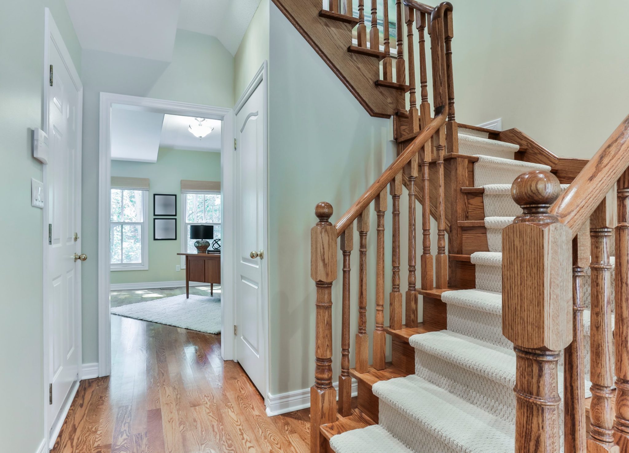 An image depicting a home staircase with sturdy railings and a secure rug serves as a reminder of the importance of a personal injury attorney in Rockford, who can offer legal expertise and support to individuals who have suffered injuries due to slip and fall accidents within residential properties.